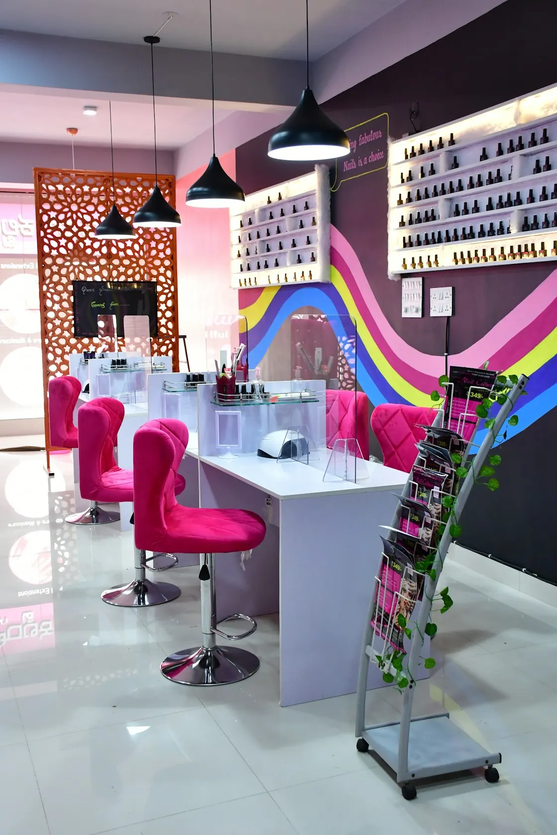 Modern beauty salon with pink chairs and manicure stations