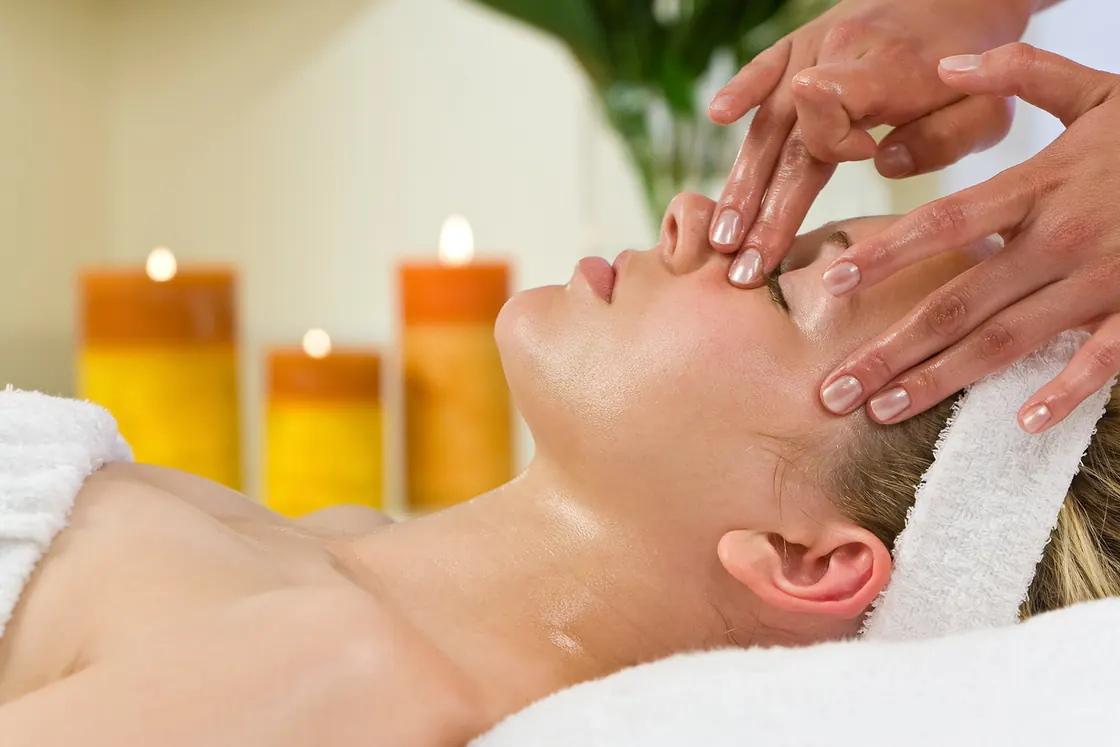 Facial massage in a spa with candles